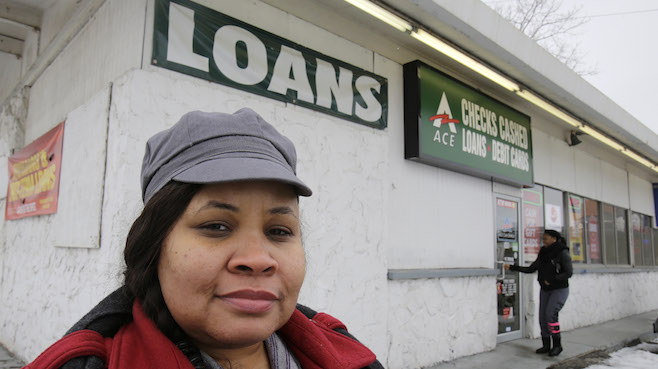 Maranda Brooks stands outside a payday loans business that she frequented in the past Thursday Jan. 22 2015 in Cleveland. Troubled by consumer complaints and loopholes in state laws federal regulators are putting together expansive first-ever rules