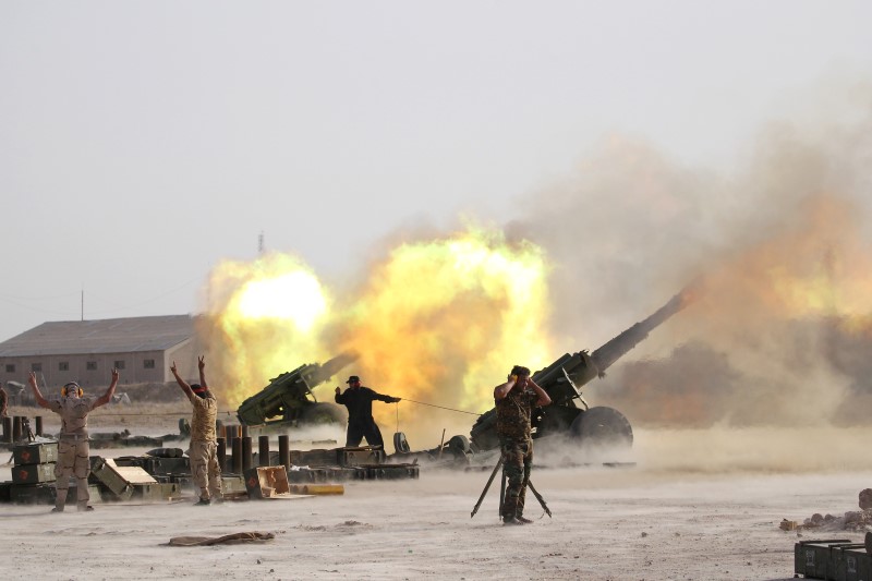 ReutersIraqi security forces and Shi'ite fighters fire artillery towards Islamic State militants near Fallujah Iraq