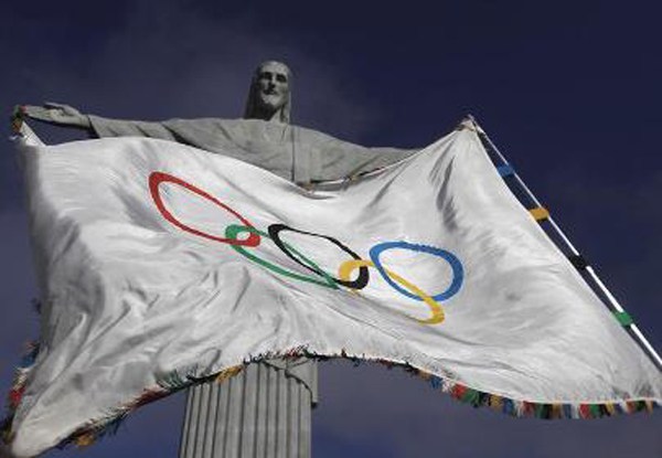 The Olympic Flag flies in front of'Christ the Redeemer statue during a blessing ceremony in Rio de Janeiro