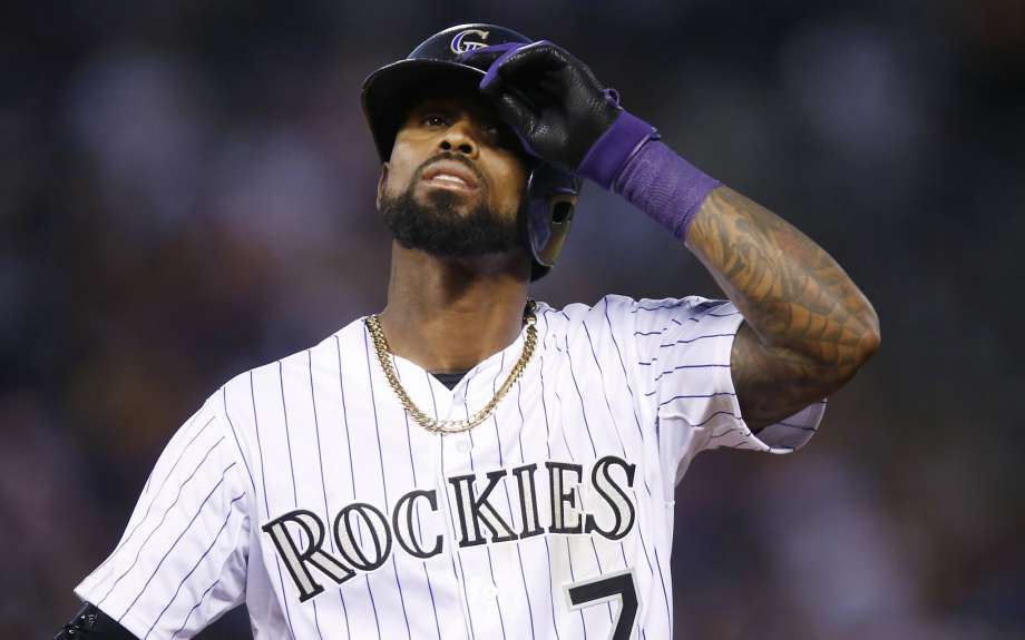 Colorado Rockies shortstop Jose Reyes is shown adjusting his helmet while facing the Seattle Mariners in an interleague baseball game. Rather than activate Reyes following his domestic violence suspension the Ro