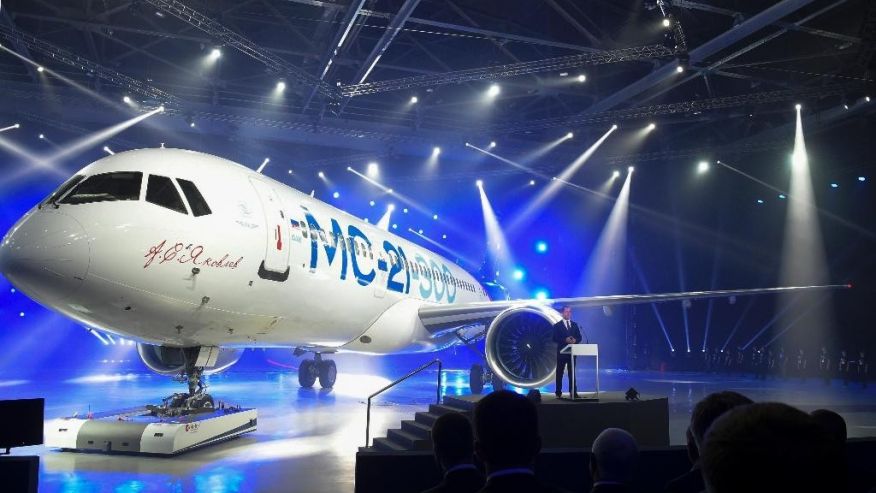 Russian Prime Minister Dmitry Medvedev speaks at the unveiling ceremony of a new passenger jet MC-21-300 at a plane at'Irkut corporation assembling plant in Irkutsk Russia Wednesday