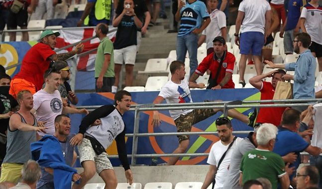 Russian supporters attack England fans at the end of the Euro 2016 Group B soccer match between England and Russia at the Velodrome stadium in Marseille France Saturday