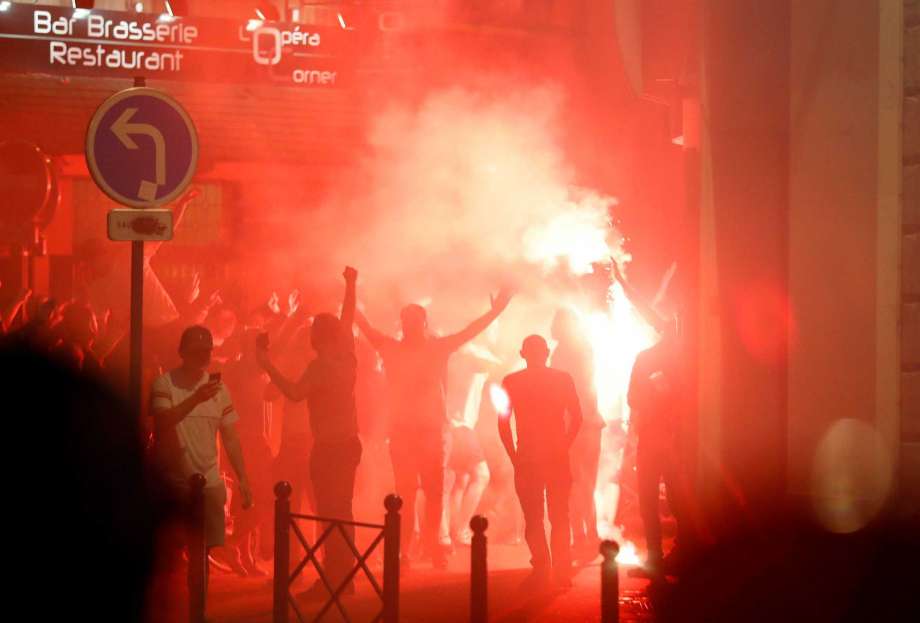 England supporters gesture towards a line of police officers during a standoff in downtown Lille France Wednesday