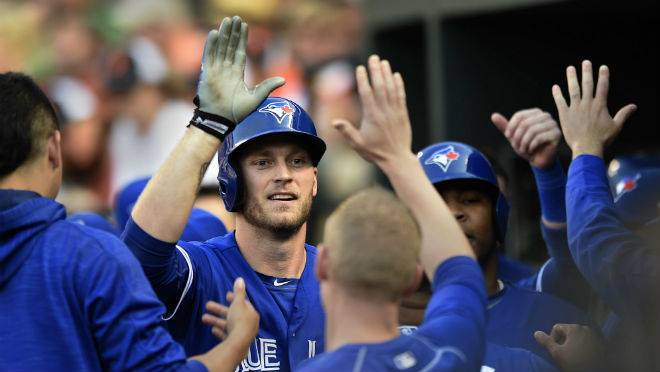 Toronto Blue Jays&#039 Michael Saunders center is congratulated after hitting a three-run home run against the Baltimore Orioles in the first inning of a baseball game in Baltimore on Friday