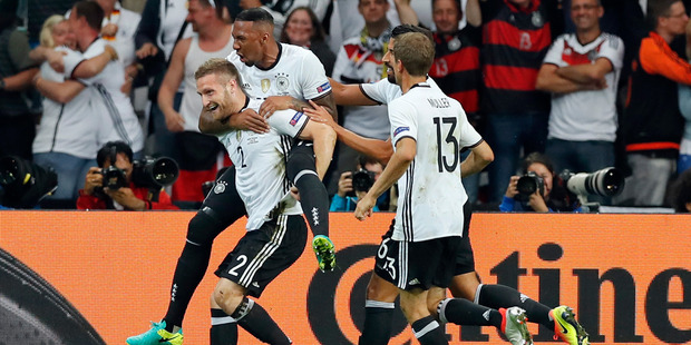 Germany's Shkodran Mustafi left celebrates after scoring the opening goal during the Euro 2016 Group C soccer match between Germany and Ukraine