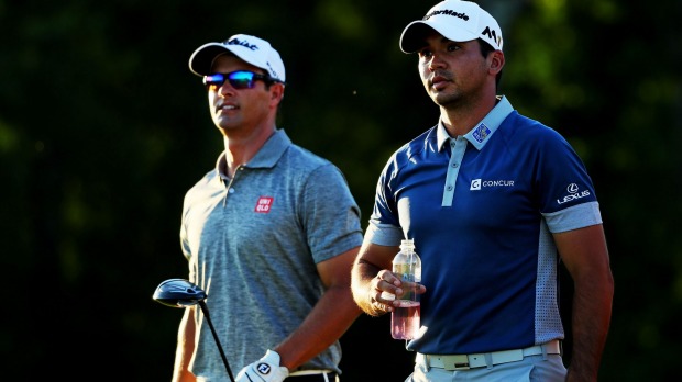 Scott and Day walk on the fourth hole during the second round