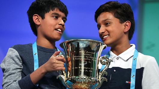 Spellers Nihar Saireddy Janga of Austin Texas and Jairam Jagadeesh Hathwar of Painted Post New York hold a trophy after the finals of the 2016 Scripps National Spelling Bee