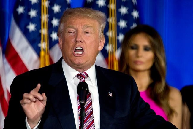 Republican presidential candidate Donald Trump is joined by his wife Melania as he speaks during a news conference at the Trump National Golf Club Westchester Tuesday