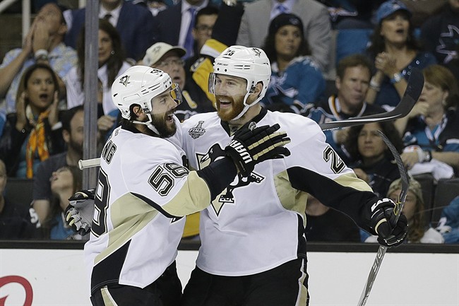 Pittsburgh Penguins&#39 Ian Cole right celebrates with Kris Letang after scoring a goal against the San Jose Sharks during the first period of Game 4 of the NHL hockey Stanley Cup Finals on Monday