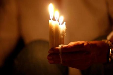 A woman lit candles during a vigil in solidarity with Jordanian soldiers who were killed in an attack on a border military post near a camp for Syrian refugees Tuesday