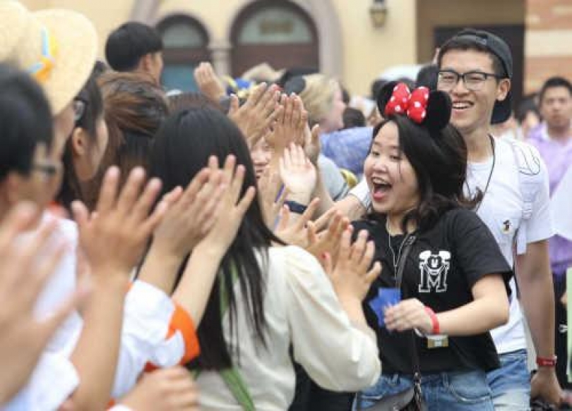 Staff members welcome visitors after the opening ceremony of the Shanghai Disney Resort