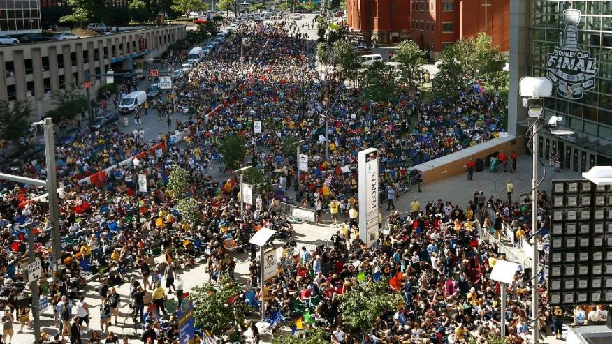 A throng of fans gather to watch Game 5 of the NHL hockey Stanley Cup Finals between the Pittsburgh Penguins and the San Jose Sharks on a big screen in front of the Consol Energy Center Thursday