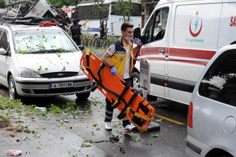 A Turkish medic rushes in to work at the explosion site after a bus carrying riot police official was struck by a bomb in Istanbul Tuesday