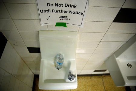 A sign is seen next to a water dispenser at North Western high school in Flint a city struggling with the effects of lead-poisoned drinking water in Michigan