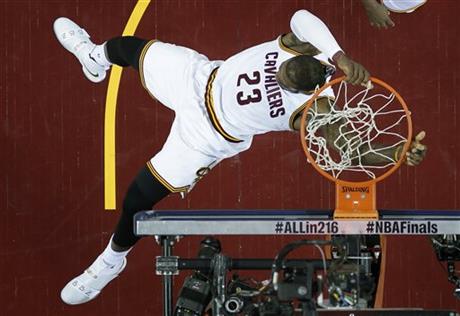 Cleveland Cavaliers forward Le Bron James dunks against the Golden State Warriors during the first half of Game 6 of basketball's NBA Finals in Cleveland Thursday