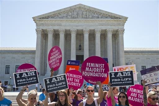 Demonstrators on both sides of the abortion issue stand in front of the Supreme Court in Washington Monday