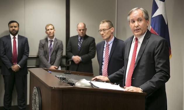 Republican Texas Attorney General Ken Paxton,right announces Texas&#039 lawsuit to challenge President Obama's transgender bathroom order during a news conference in Austin Texas Wednesday