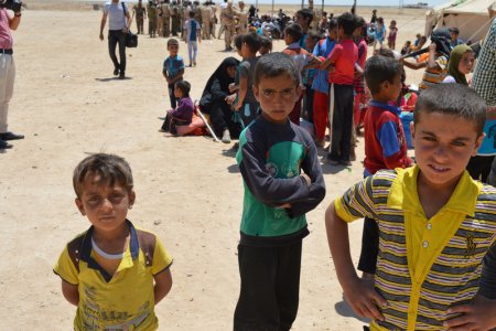 Children who fled their homes due to the clashes in Falluja pose for the