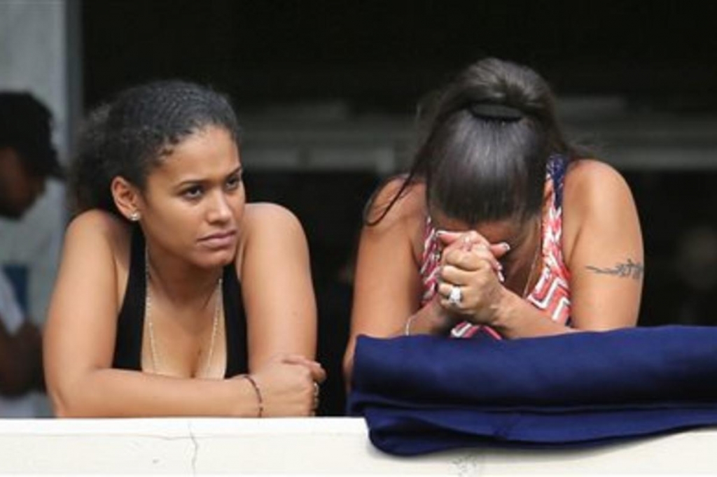 Concerned friends and family of victims at the Pulse nightclub where multiple fatalities were reported after a shooting wait outside of the Orlando Police Department Sunday