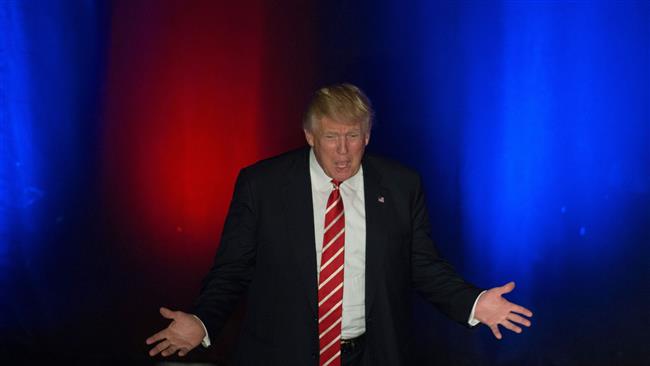 Republican presidential candidate Donald Trump walks on stage to speak during a campaign stop at the Fox Theater