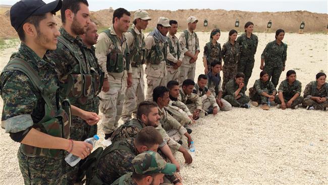 2016 members of the Syrian Democratic Forces gather after a training session at a firing range in northern Syria