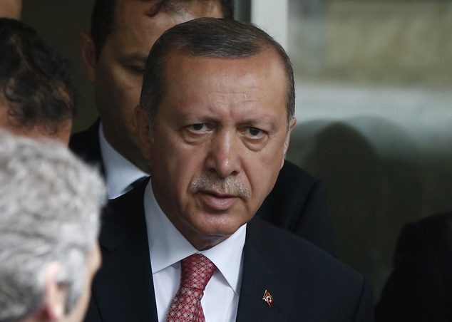 Turkey's President Recep Tayyip Erdogan walks outside a hospital after visiting wounded people near an explosion site in Istanbul Tuesday