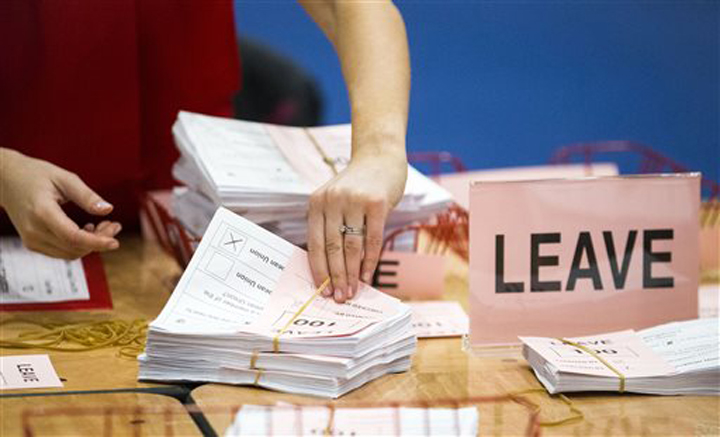 A teller counts ballot papers at the Titanic Exhibition Centre in Belfast Northern Ireland after polls closed in the EU referendum Thursday