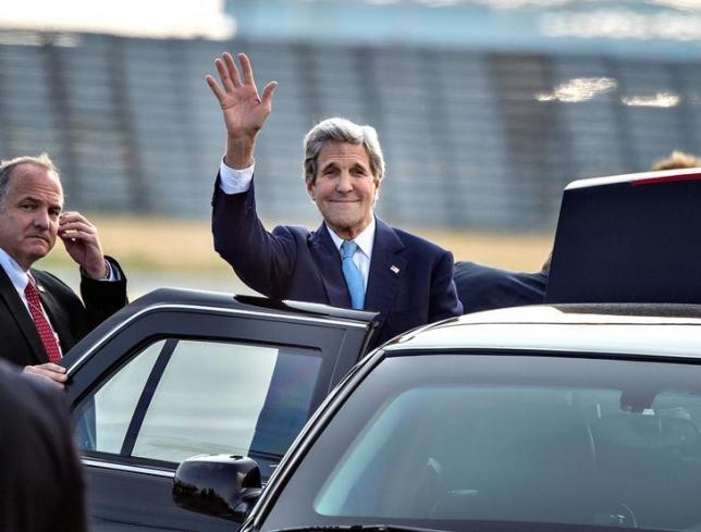 U.S. Secretary of State John Kerry waves as he arrives at Copenhagen Airport for a two-day visit in Denmark