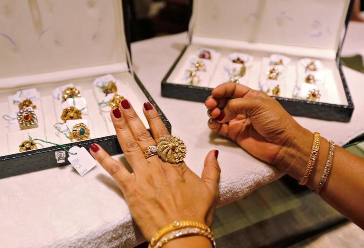 A woman tries on a gold ring inside a jewellery showroom on the occasion of Akshaya Tritiya in Ahmedabad