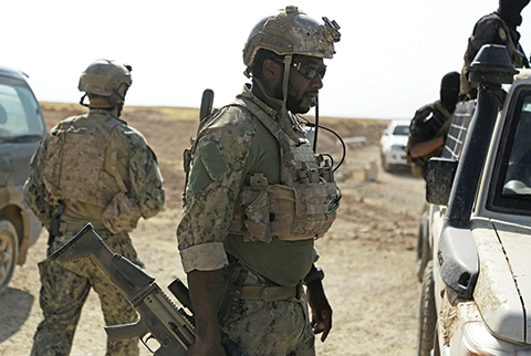 Armed men in uniform identified by Syrian Democratic forces as US special operations forces are seen in the village of Fatisah in the northern Syrian province of Raqa