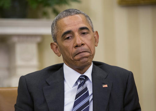 President Barack Obama pauses while speaking to members of the media in the Oval Office of the White House in Washington Monday