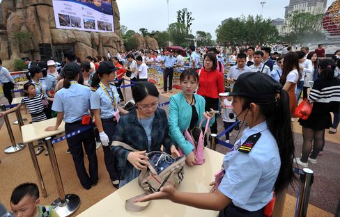 Visitors pass through a security checkpoint to enter Wanda Cultural Tourism City in Nanchang