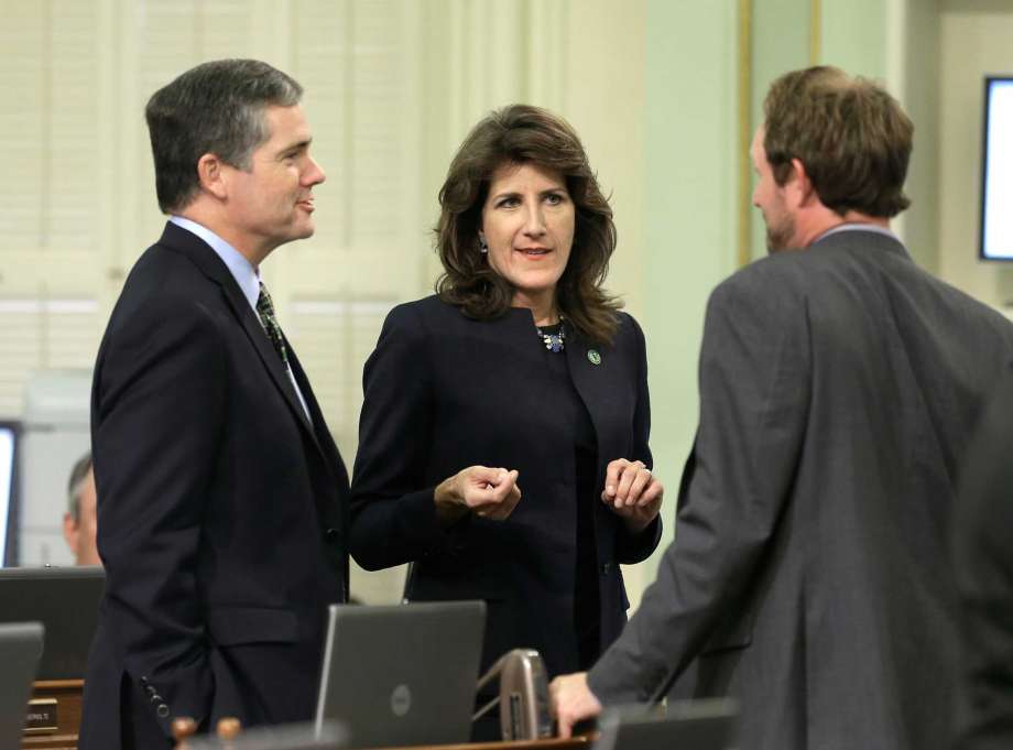 Republican Assembly members David Hadley of Manhattan Beach left Catharine Baker of Dublin and James Gallagher of Nicolaus huddle during the Assembly session in Sacramento Calif. Democrats are spending