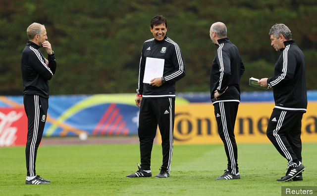 Wales coach Chris Coleman with a teamsheet during training