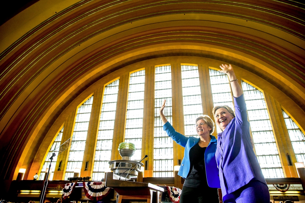 ClintonWarren02-1 Democratic presidential candidate Hillary Clinton accompanied by Sen. Elizabeth Warren D-Mass. left waves after speaking Monday at the Cincinnati Museum Center at Union Terminal in Cincinnati. Their first combined campaign appearance