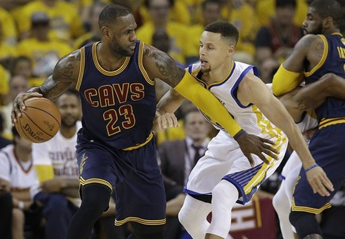 The Associated Press | Cleveland Cavaliers forward Le Bron James dribbles against Golden State Warriors guard Stephen Curry during the first half of Game 1 of basketball's NBA Finals in Oakland Calif. Thursday