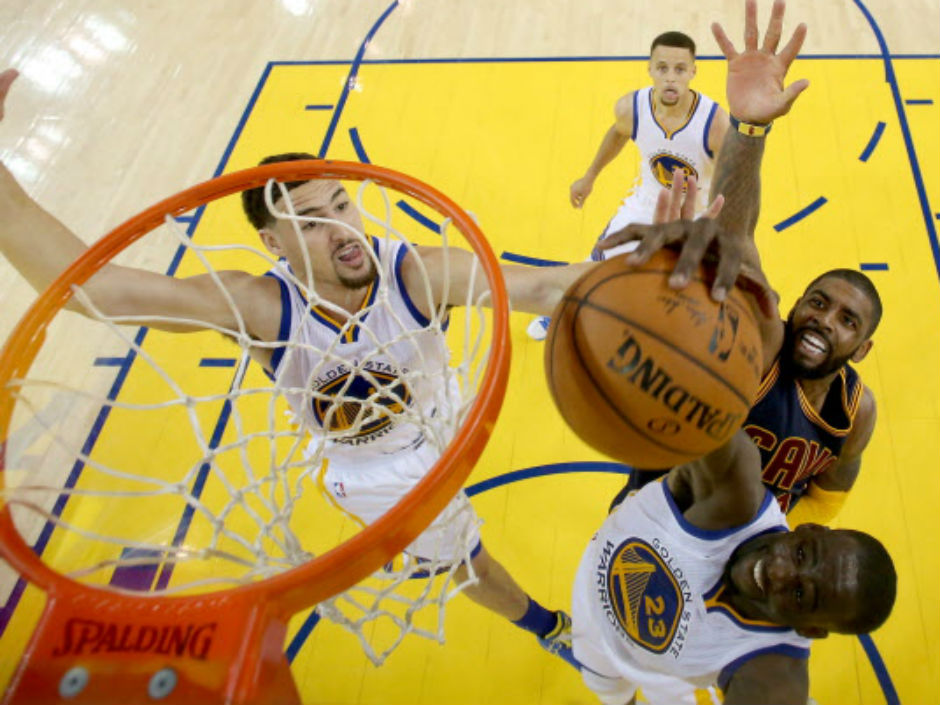 Draymond Green right of the Golden State Warriors powers past Kyrie Irving of the Cleveland Cavaliers as he dunks the ball during Game 1 action in the NBA Finals Thursday night in Oakland. Green had 16 points in the Warriors&#039 104-88 victory. Game 2