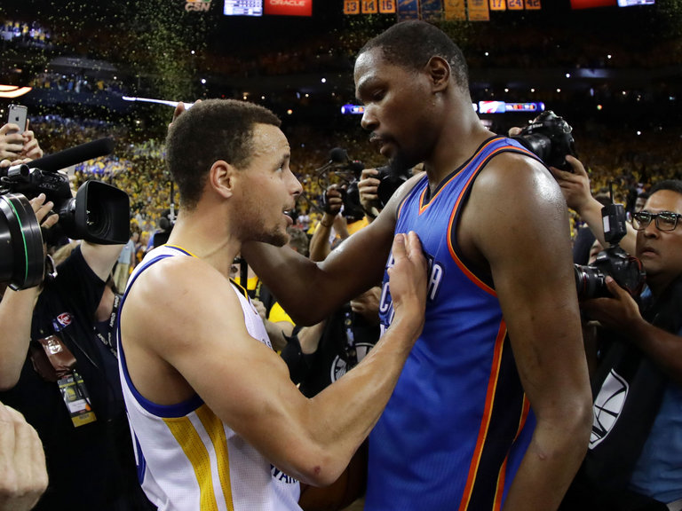 Stephen Curry speaks with Kevin Durant after the game