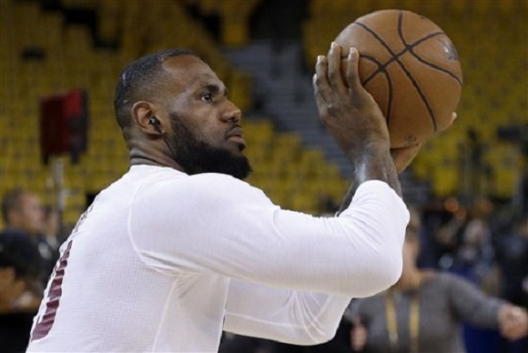 Cleveland Cavaliers forward Le Bron James warms up before Game 5 of basketball's NBA Finals against the Golden State Warriors in Oakland Calif. Sunday