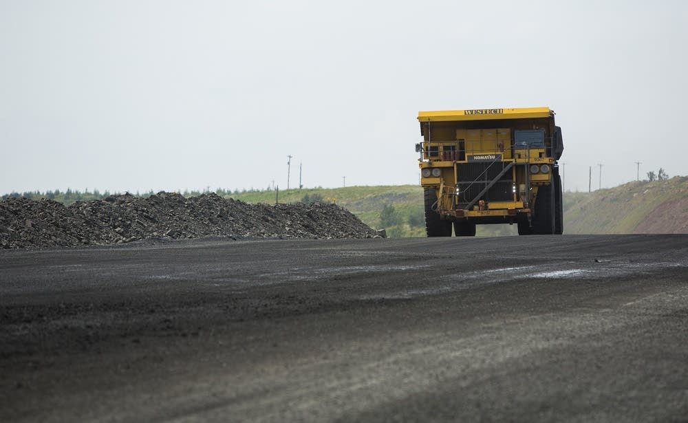 A haul truck advanced on a wide mining road