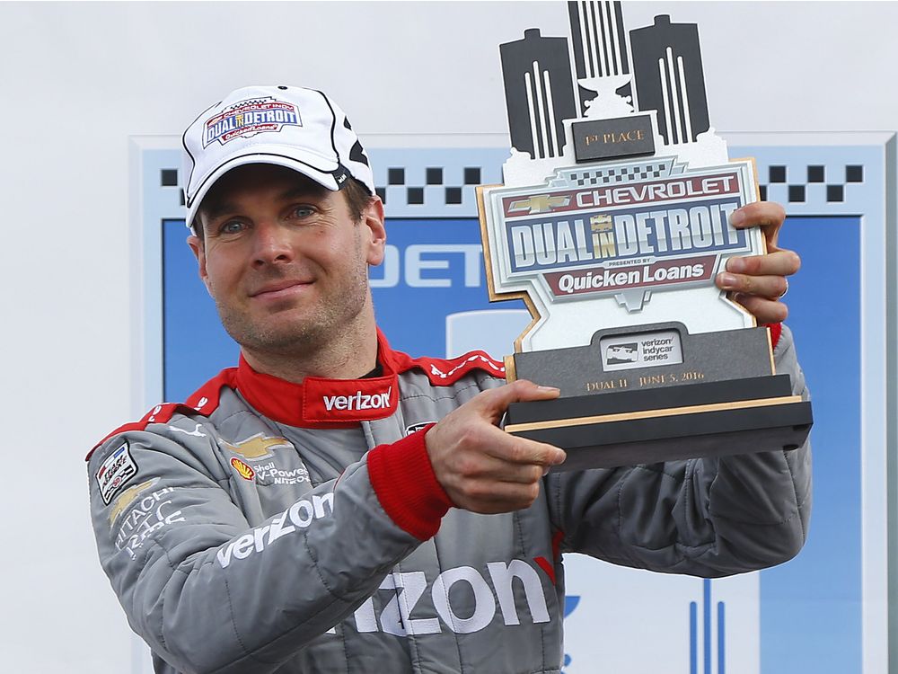 Will Power celebrates with the trophy after winning race two of the Indy Car Detroit Grand Prix auto racing doubleheader on Belle Isle in Detroit Sunday