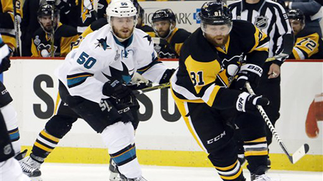 Pittsburgh Penguins Phil Kessel carries the puck past San Jose Sharks Chris Tierney during the first period in Game 2 of the NHL hockey Stanley Cup Finals on Wednesday