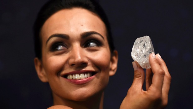 A model shows off the 1109-carat'Lesedi La Rona, the largest gem quality rough diamond discovered in more than 100 years