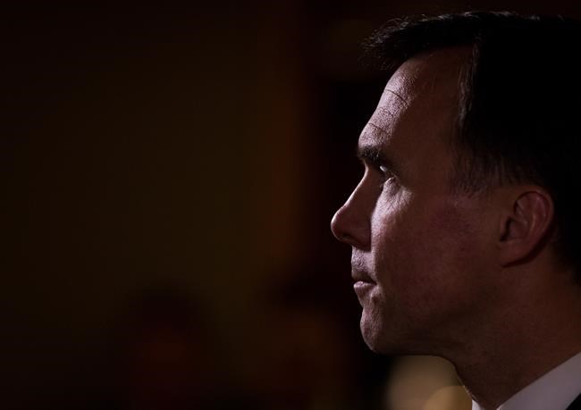 Federal Finance Minister Bill Morneau listens during a news conference after reaching a deal with his provincial and territorial counterparts to expand the Canada Pension Plan in Vancouver B.C. on Monday