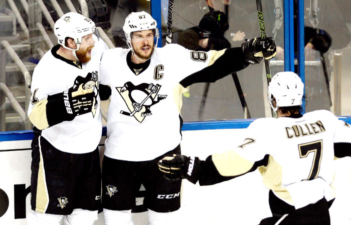 Sidney Crosby of the Pittsburgh Penguins celebrates with his teammates Phil Kessel and Matt Cullen after scoring a goal against the Tampa Bay Lightning in Game Six of the Eastern Conference finals at Amalie Arena in Tampa Florida Tuesday. — A