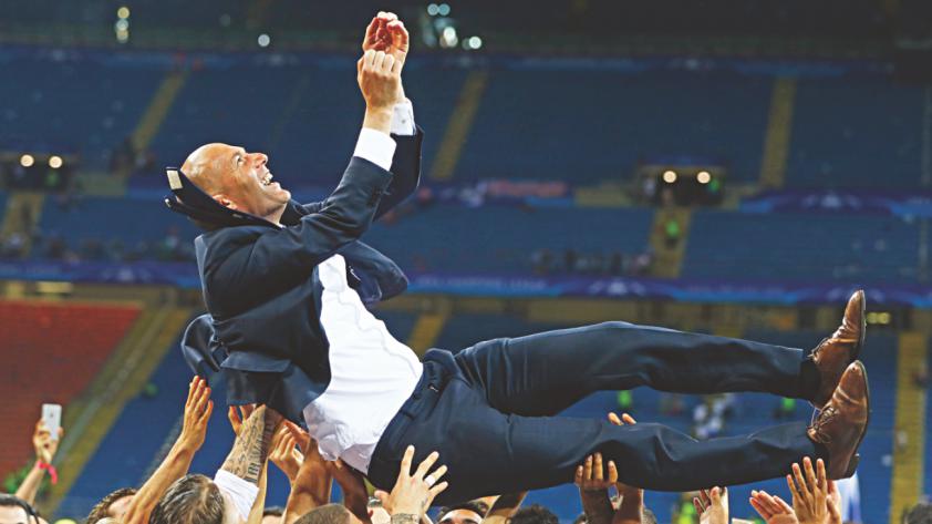 Zinedine Zidane is thrown into the air by his jubilant players after their Champions League final win on Saturday