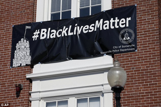 A ‘Black Lives Matter’ banner hangs at the main entrance of City Hall in Somerville