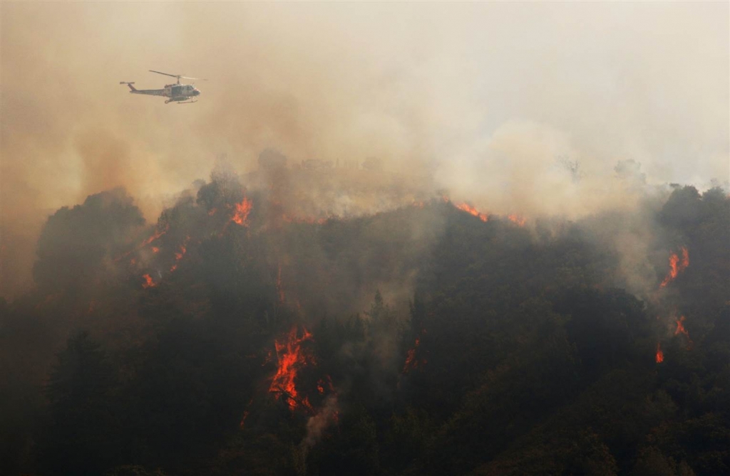 Image A Cal Fire helicopter flies over Williams Canyon during the Soberanes Fire near Carmel Valley