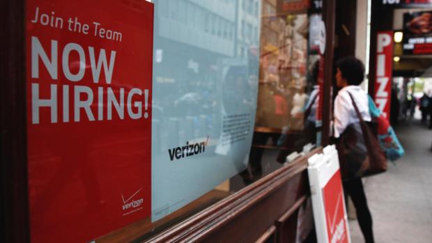 A'Now Hiring sign is posted on a Verizon store in Manhattan in New York City