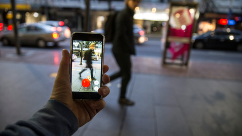 A Pokemon reveals itself on Queen St as commuters walk on